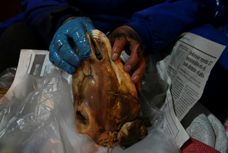 Claudia Arispea displays a sheep's head, which is cooked for seven or eight hours to make it tender